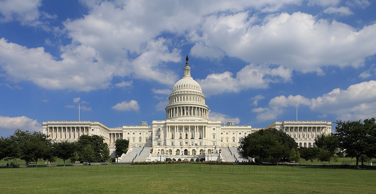 United States Capitol building west side under a blue sky