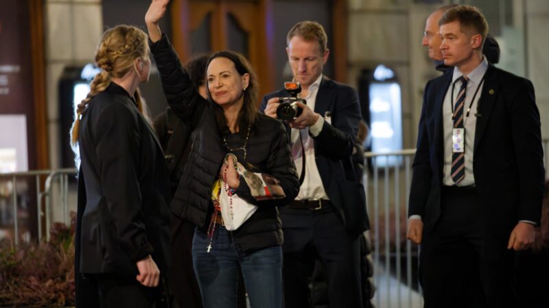 Maria Corina Machado waving to supporters during Nobel Week 2025