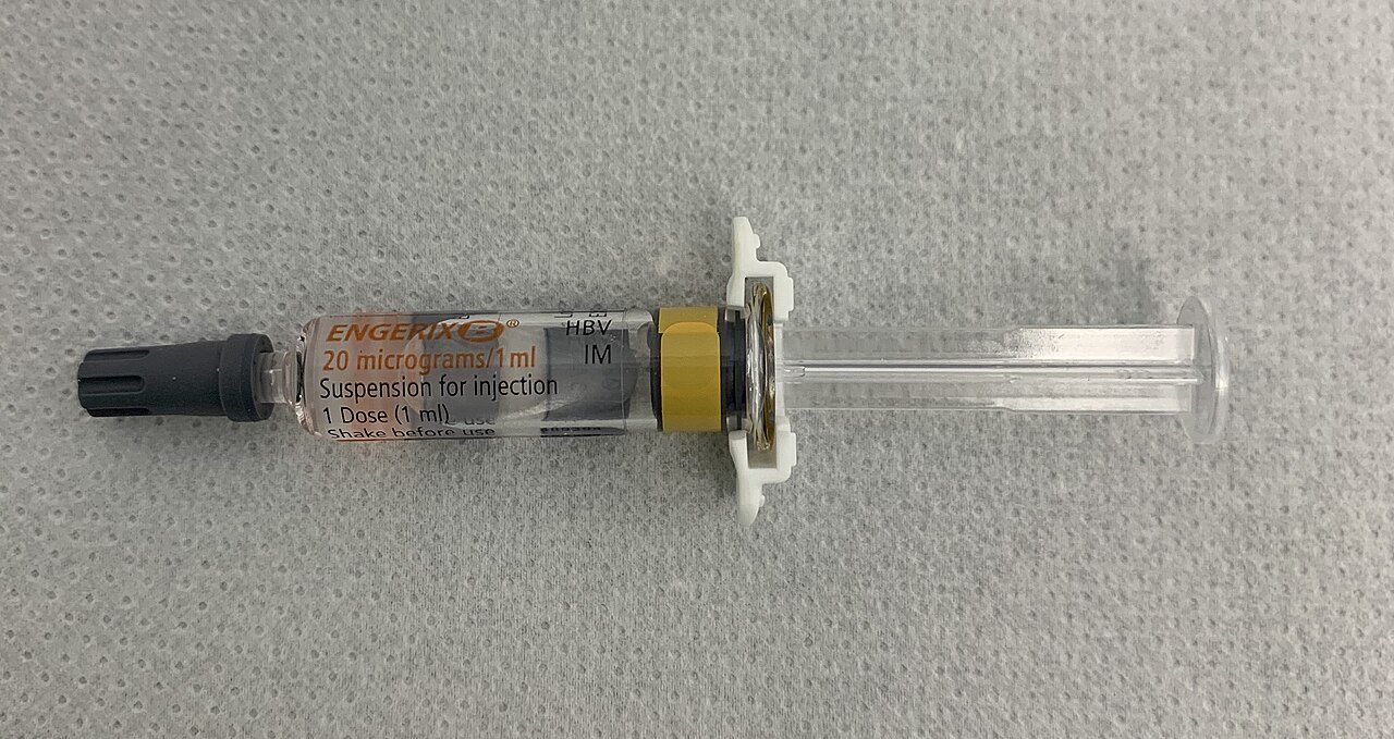 A pre-filled hepatitis B vaccine syringe lying on a clinical surface