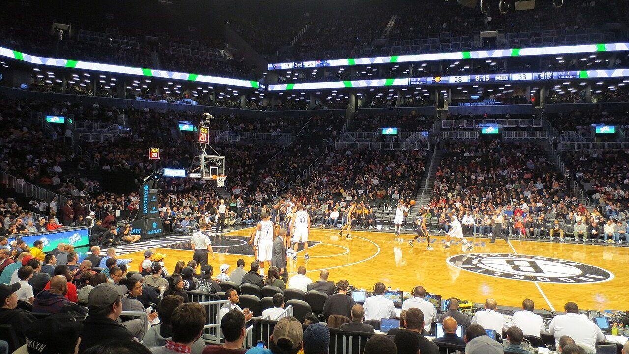 Basketball game in progress before a large crowd inside Brooklyn's Barclays Center arena