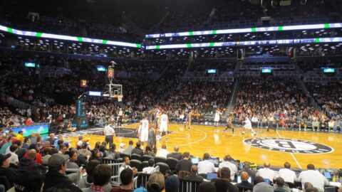 Basketball game in progress before a large crowd inside Brooklyn's Barclays Center arena