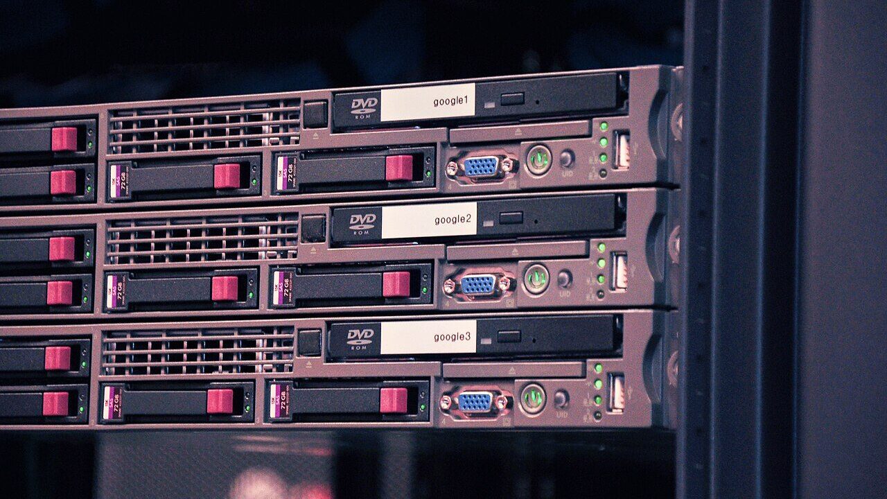 Rows of Google server racks with labelled drives inside a data centre
