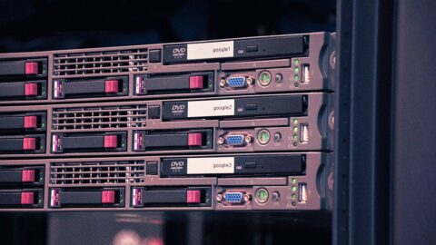 Rows of Google server racks with labelled drives inside a data centre