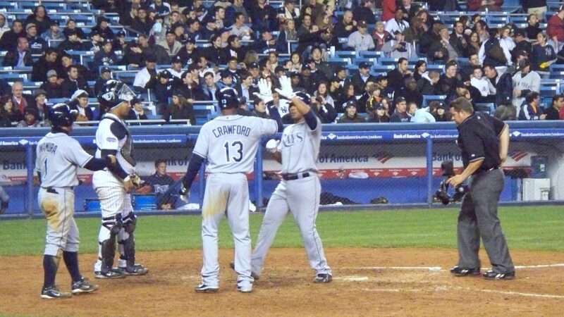 Tampa Bay Rays players celebrating a home run at home plate