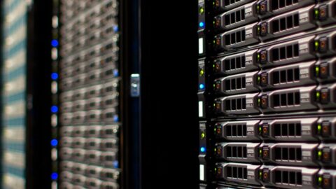 Rows of server racks with blinking lights inside a data centre