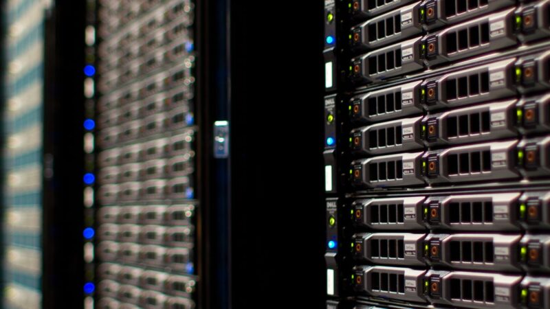 Rows of server racks with blinking lights inside a data centre