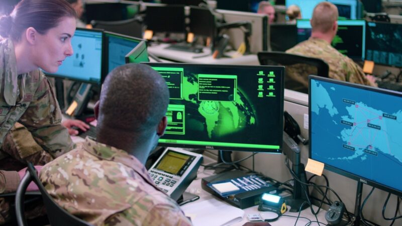 Cybersecurity operations staff monitoring screens in an operations centre